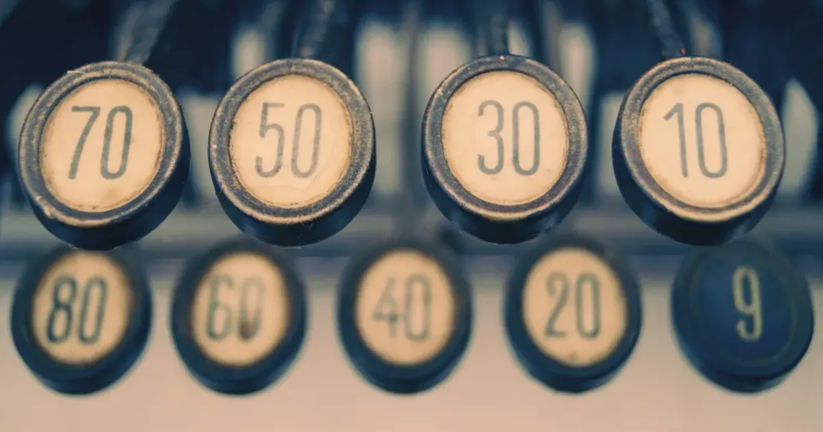 An old-school mechanical keyset with the numbers 70, 50, 30, and 10 from right to left. The keys are round and worn.